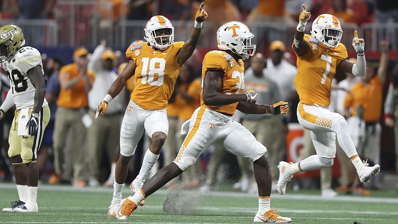 Tennessee Athletics photo / Tennessee defenders Nigel Warrior (18), Daniel Bituli (35) and Rashaan Gaulden (7) celebrate a stop during the 42-41 double-overtime triumph over Georgia Tech in 2017 inside Atlanta's Mercedes-Benz Stadium.