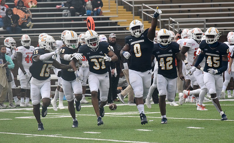 Staff photo by Matt Hamilton / UTC defensive lineman Quay Wiggles (0) celebrates with teammates after defensive back Jelen Lee (37) intercepted a pass during a SoCon game against Mercer on March 27 at Finley Stadium.