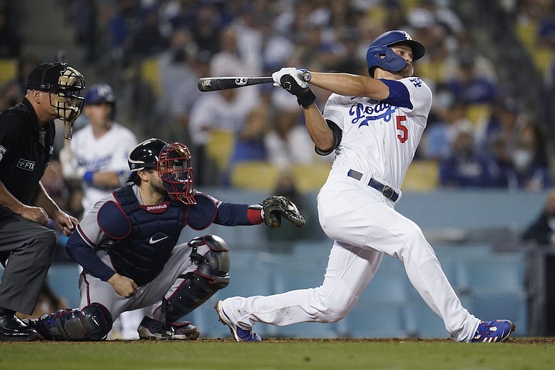 Los Angeles Dodgers' Corey Seager follows through on his RBI double during the eighth inning against the Atlanta Braves in a baseball game Tuesday, Aug. 31, 2021, in Los Angeles. (AP Photo/Marcio Jose Sanchez)