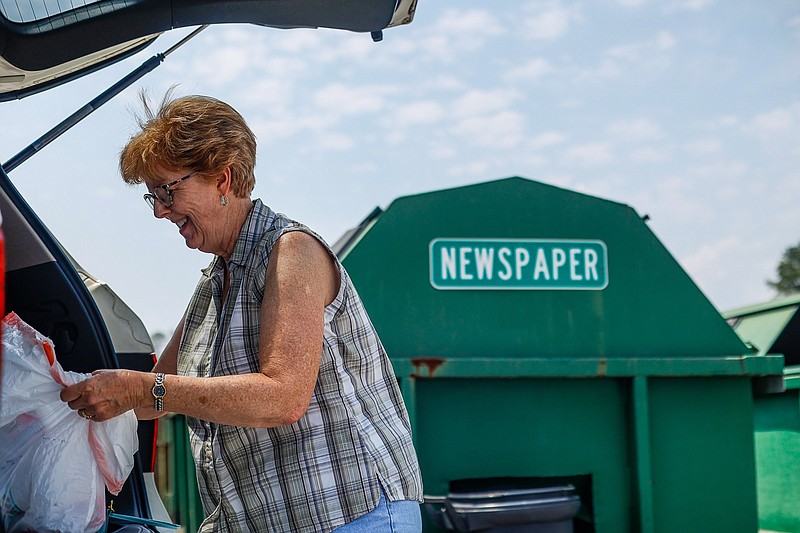 Staff photo by Troy Stolt / Jenny Allen grabs items in need of recycling out of her trunk at the city of Chattanooga Recycling Center at 8004 Batters Place Road on Tuesday, Aug. 3, 2021, in East Brainerd, Tenn.