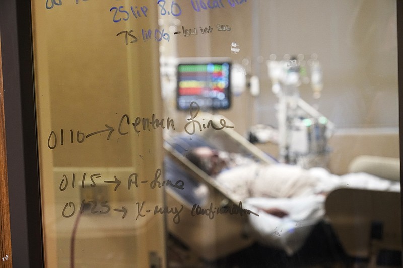 AP Photo/Gerald Herbert / Medical notations are written on a window of a COVID-19 patient's room in an intensive care unit at the Willis-Knighton Medical Center in Shreveport, La., on Aug. 18, 2021.