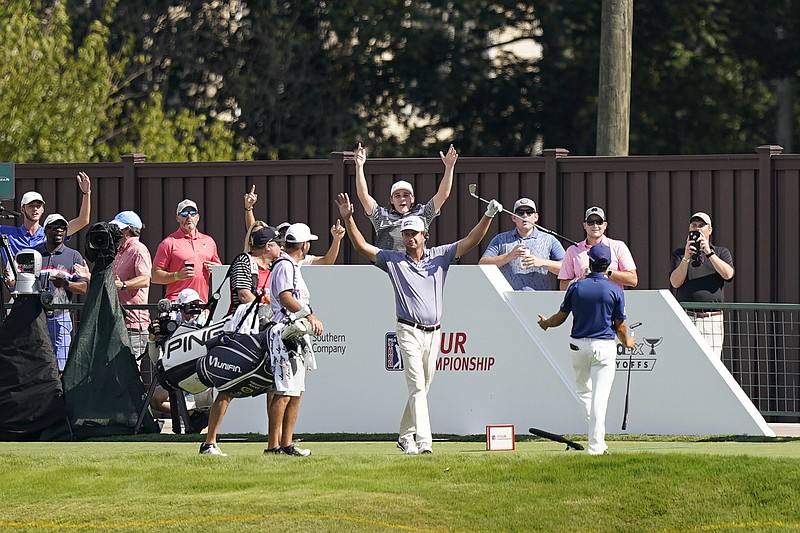 AP photo by Brynn Anderson / Baylor School graduate Harris English, center, celebrates after hitting a hole-in-one on No. 15 at East Lake Golf Club during Thursday's first round of the Tour Championship in Atlanta.