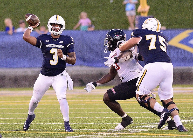 Staff photo by Robin Rudd / UTC's Drayton Arnold (3) passes as Harrison Moon (75) blocks during Thursday night's game against Austin Peay at Finley Stadium.