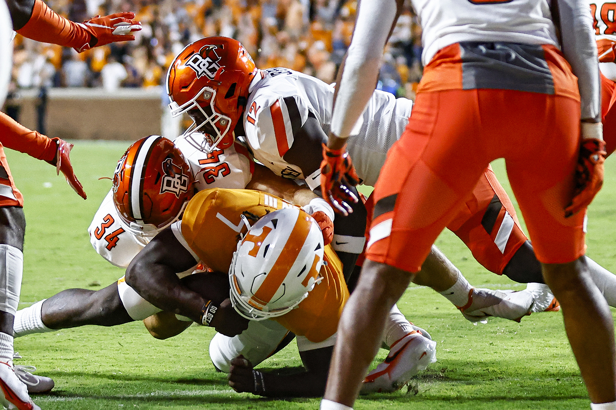 Tennessee quarterback Joe Milton III (7) dives across the goal line as he's hit by Bowling Green linebackers Brock Horne (34) and JB Brown (12) during the first half of an NCAA college football game Thursday, Sept. 2, 2021, in Knoxville, Tenn. (AP Photo/Wade Payne)
