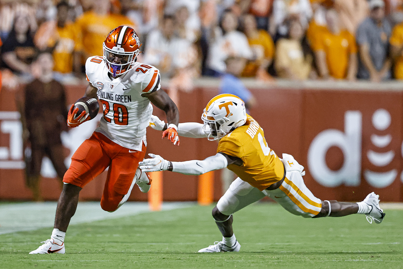 Bowling Green running back Jamal Johnson (20) gets past Tennessee defensive back Warren Burrell (4) during the first half of an NCAA college football game Thursday, Sept. 2, 2021, in Knoxville, Tenn. (AP Photo/Wade Payne)