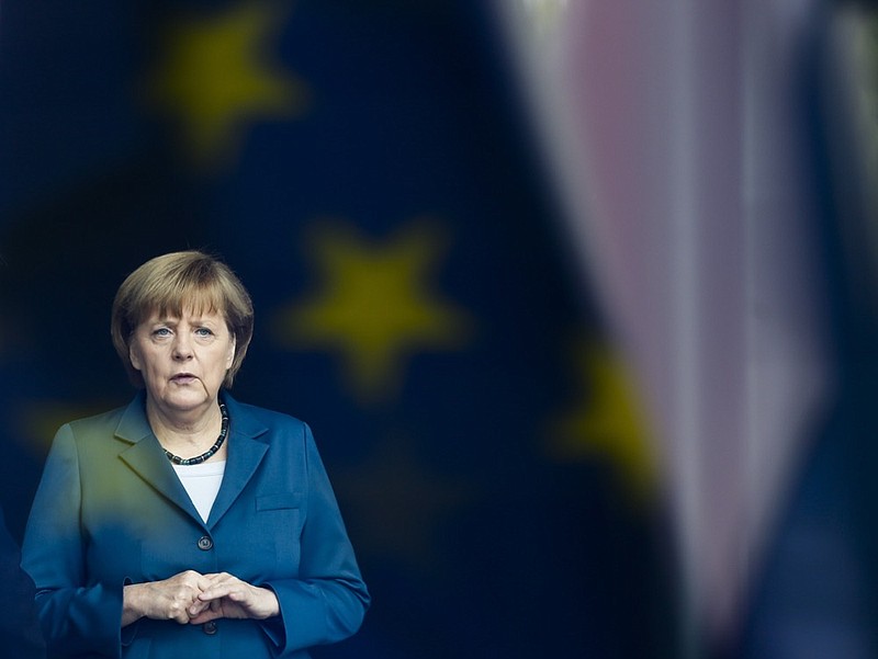 In this Monday, June 3, 2013 file photo, German Chancellor Angela Merkel stand behind a window with a reflection of the European flag as she waits for the arrival of King Willem-Alexander of the Netherlands at the chancellery in Berlin. (AP Photo/Markus Schreiber, File)


