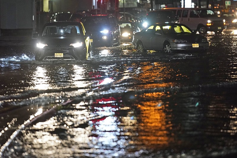 Cars make their way through flooded streets and around abandoned cars in Teterboro, N.J., Thursday, Sept. 2, 2021. (AP Photo/Seth Wenig)

