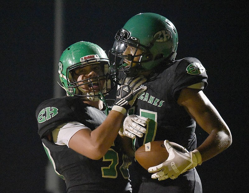 Staff file photo by Matt Hamilton / East Hamilton running back Juan Bullard, right, needed just five carries to total 125 yards and three touchdowns in the Hurricanes' 49-0 win against visiting East Hamilton in the region opener for both teams Friday night.