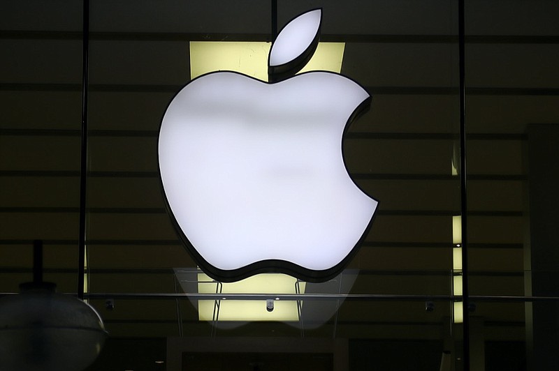 FILE - In this Wednesday, Dec. 16, 2020 file photo, the logo of Apple is illuminated at a store in the city center in Munich, Germany. (AP Photo/Matthias Schrader, file)


