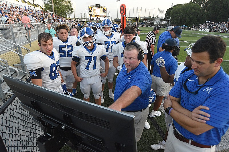 Staff photo by Matt Hamilton / McCallie football players and coaches review plays on a sideline monitor during a game at Georgia power Calhoun on Aug. 27. McCallie improved to 3-0 by winning its region opener Friday at Montgomery Bell Academy in Nashville.