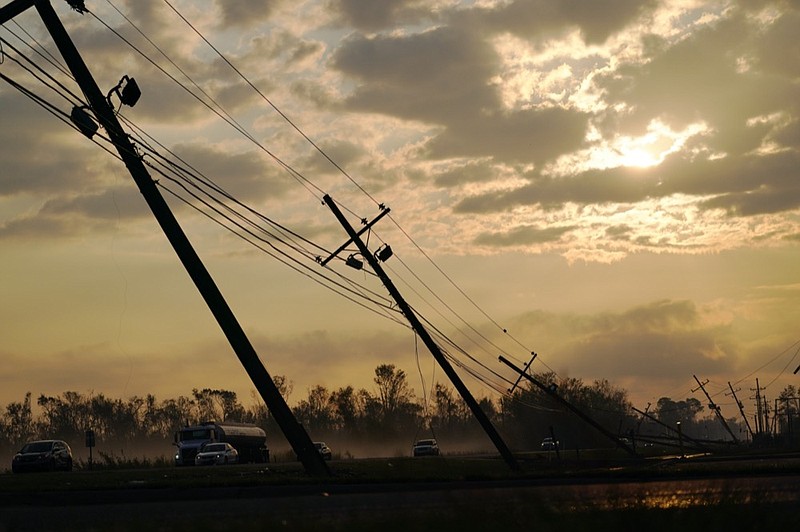 Downed power lines slump over a road in the aftermath of Hurricane Ida, Friday, Sept. 3, 2021, in Reserve, La. (AP Photo/Matt Slocum)


