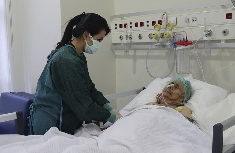 A nurse monitors Ayse Karatay at the City Hospital in Eskisehir, western Turkey, Saturday, Sept. 4, 2021. Karatay, a 116-year-old Turkish woman has survived COVID-19, her son said, making her one of the oldest patients to beat the disease. Ayse Karatay spent three weeks in intensive care and was moved to a normal ward, her son Ibrahim Karatay told the Demiroren news agency. (IHA via AP)


