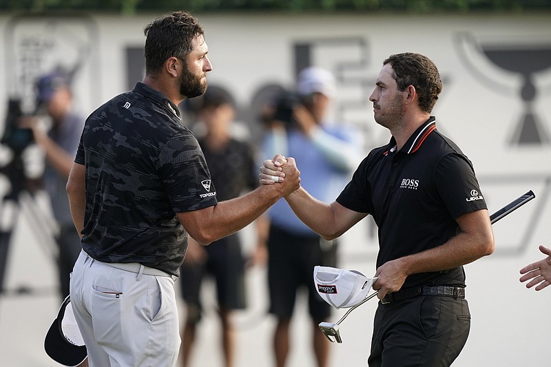 AP photo by Brynn Anderson / Jon Rahm, left, shakes hands with Patrick Cantlay on the 18th green at East Lake Golf Club during the third round of the Tour Championship in Atlanta. Cantlay held off Rahm on Sunday to win the tournament and the PGA Tour's season prize of the FedEx Cup.