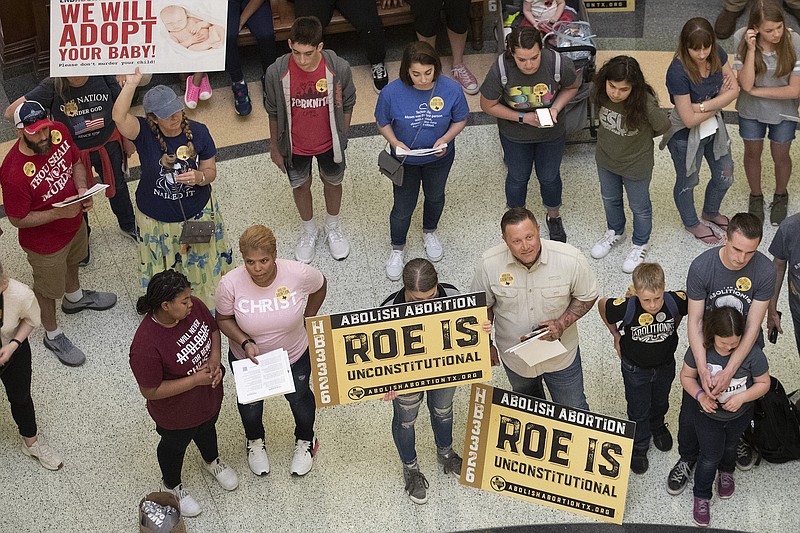 Photo by Jay Janner/Austin American-Statesman via AP, File / In this March 30, 2021 file photo, anti-abortion rights demonstrators gather in the rotunda at the Capitol while the Senate debated anti-abortion bills in Austin, Texas.