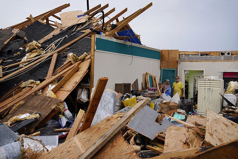 Guthrie Matherne, left, and Blakland Matherne, right, looks at what remains of their hurricane destroyed business in the aftermath of Hurricane Ida, Monday, Sept. 6, 2021, in Lockport, La. (AP Photo/John Locher)