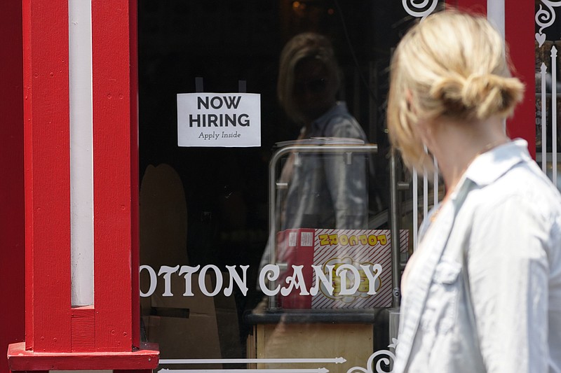 A "NOW HIRING" sign is posted in the window of The Wharf Chocolate Factory at Fisherman's Wharf in Monterey, Calif., Friday, Aug. 6, 2021. California employers are adding new jobs at a record-breaking pace even as the state's unemployment claims remain stubbornly high, a sign the delta variant could be giving people pause about returning to work. (AP Photo/Rich Pedroncelli)