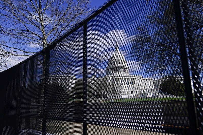 In this April 2, 2021, file photo, the U.S. Capitol is seen behind security fencing on Capitol Hill in Washington. Law enforcement concerned by the prospect for violence at a rally in the nation's Capitol next week are planning to reinstall protective fencing that surrounded the U.S. Capitol for months after the Jan. 6 insurrection there, according to a person familiar with the discussions. (AP Photo/Carolyn Kaster, File)