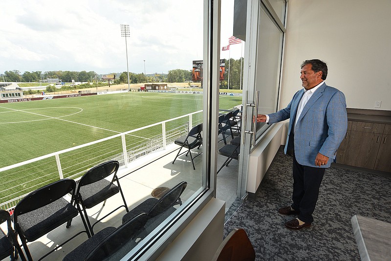 Staff Photo by Matt Hamilton / Bob Martino opens a door at a skybox at CHI Memorial Stadium in East Ridge. New development is to start in an area south of the stadium.
