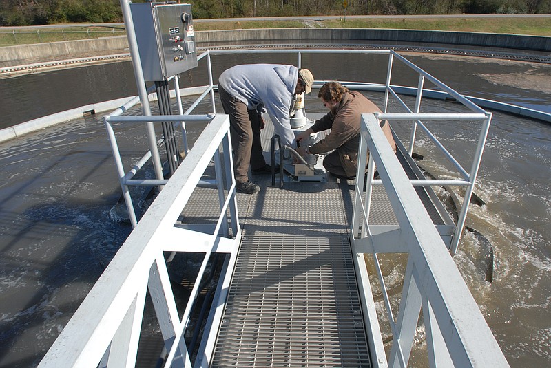 Staff file photo by Allison Kwesell / Workers make an adjustment on the drive of a wet weather water clarifier at the Moccasin Bend Wastewater Treatment Plant in 2009.