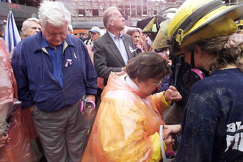 In this Sept. 20, 2001, file photo Sen. Ted Kennedy, D-Mass., left, and Sen. Joe Biden, center, stand by as Sen. Barbara Mikulski, D-Md., in orange parka, joins in prayer with rescue workers at the site of the World Trade Center in New York. They were part of a delegation of Senators that traveled by train to New York to view the rubble that once was the World Trade Center. The terrorist attacks that day shattered Americans' sense of security and ushered in a new era of nebulous threats, hidden enemies and a seemingly never-ending war on terror. And for then-Sen. Joe Biden they marked a new phase of his public life. (AP Photo/Mike Albans, Pool, File)
