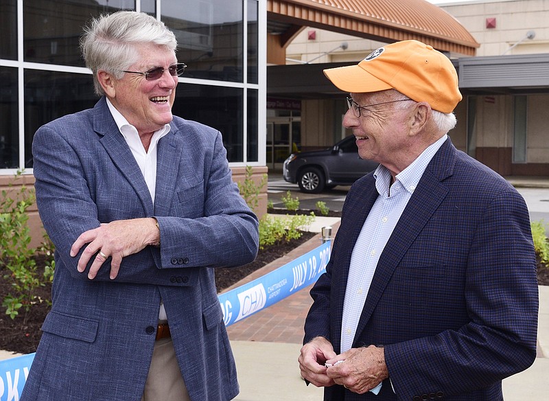 Staff File Photo by Robin Rudd / Jim Hall, right, Chattanooga Airport Authority vice chairman and former National Transportation Safety Board chairman, shares a moment with Vance Travis at a ribbon-cutting for the airport's new parking garage in July.