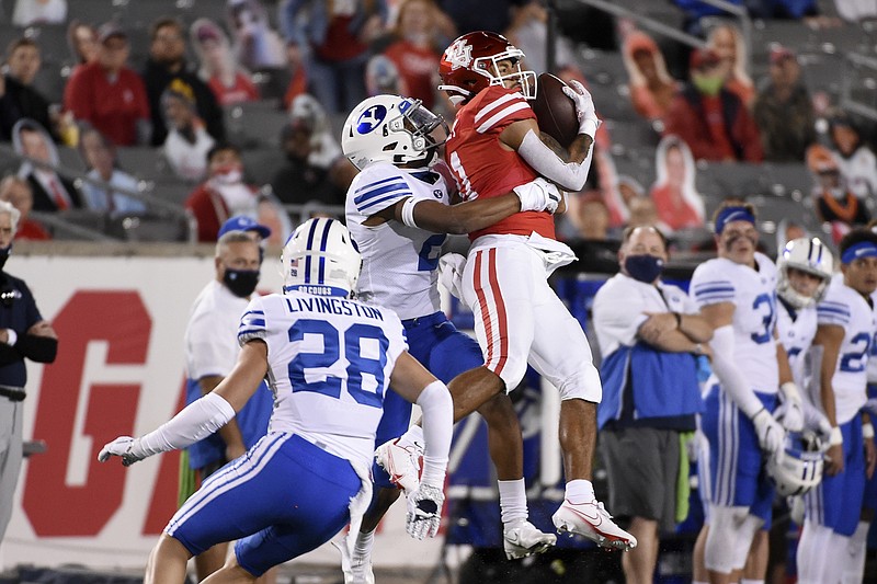 AP photo by Eric Christian Smith / Houston wide receiver Tre'von Bradley, right, catches a pass while covered by BYU defensive back Keenan Ellis on Oct. 16, 2020, in Houston.