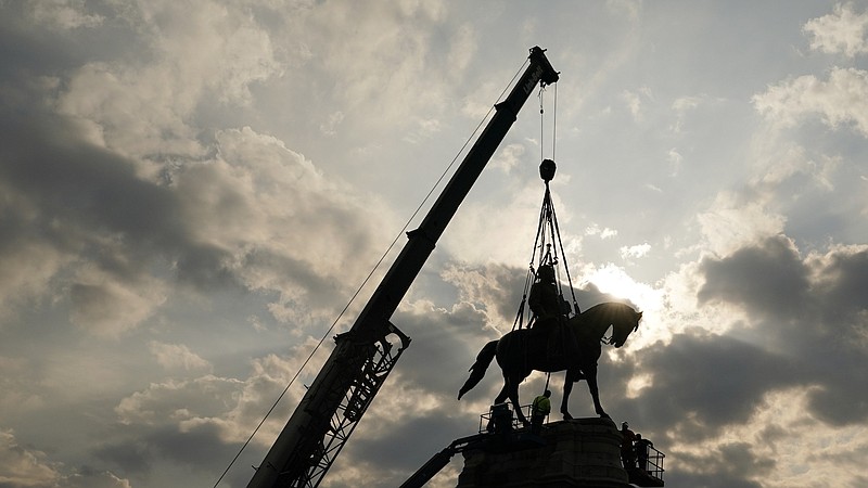AP Photo/Steve Helber, Pool / Crews work to remove one of the country's largest remaining monuments to the Confederacy, a towering statue of Confederate General Robert E. Lee on Monument Avenue, Wednesday, Sept. 8, 2021, in Richmond, Va.