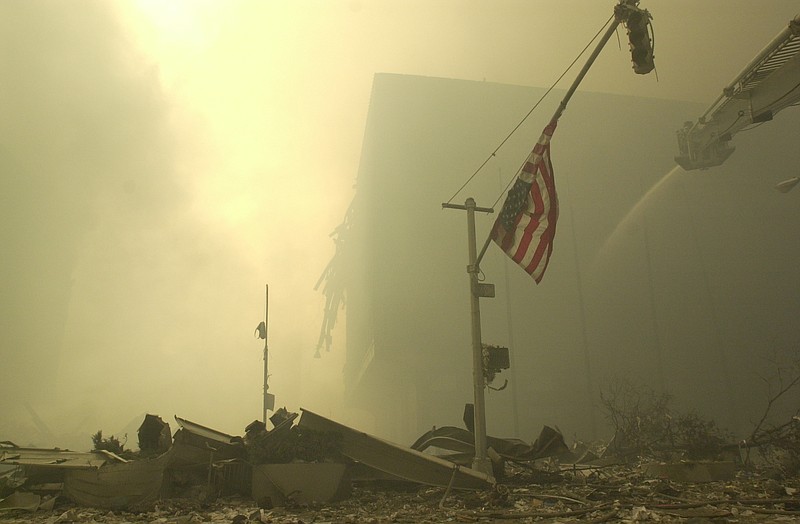 An American flag at ground zero on the evening of Sept. 11, 2001 after the September 11 terrorist attacks on the World Trade Center in New York City.(AP Photo/Mark Lennihan)


