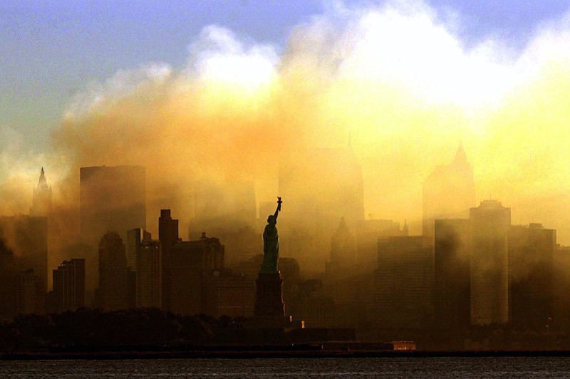 FILE - In this Saturday, Sept. 15, 2001 file photo, the Statue of Liberty stands in front of a smoldering lower Manhattan at dawn, seen from Jersey City, N.J. (AP Photo/Dan Loh, File)


