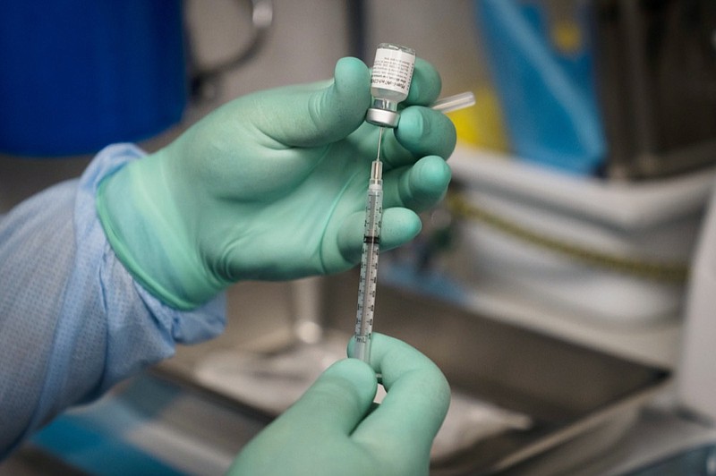 FILE - In this Thursday, Aug. 26, 2021 file photo, a syringe is prepared with the Pfizer COVID-19 vaccine at a mobile vaccine clinic in Santa Ana, Calif. (AP Photo/Jae C. Hong)


