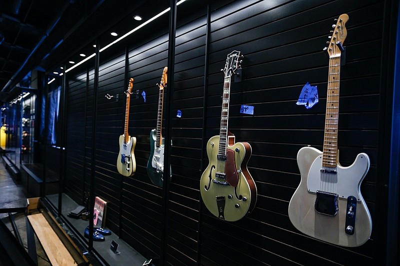 Staff photo by Troy Stolt / Guitars hang in cases at the Songbirds Foundation on Tuesday, Sept. 7, 2021 in Chattanooga, Tenn. 