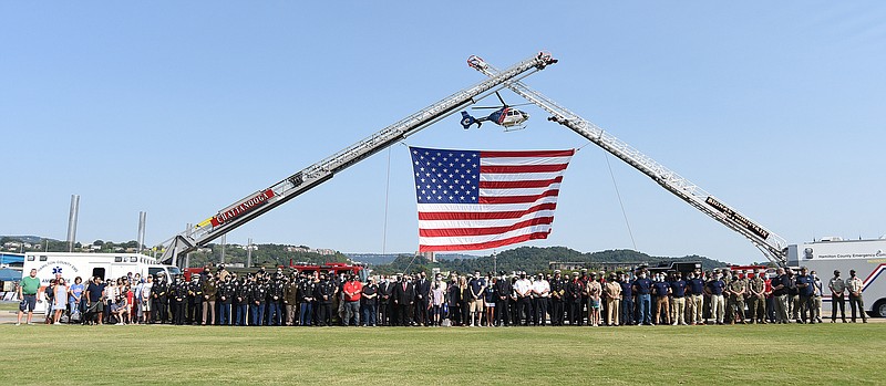 Staff Photo by Matt Hamilton / First responders and other attending the event pose for a photo on Saturday. First responders from across the region came together at Ross's Landing on Saturday, September 11, 2021 to commemorate the 20th anniversary of the terrorist attacks of Sept. 11, 2001. 