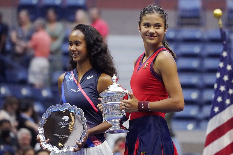 AP photo by Elisa Amendola / U.S. Open women's singles champion Emma Raducanu, right, poses for photos with runner-up Leylah Fernandez after Saturday's final in New York. Raducanu won 6-4, 6-3 to become the first player to win a Grand Slam tournament after having to go through qualifying.