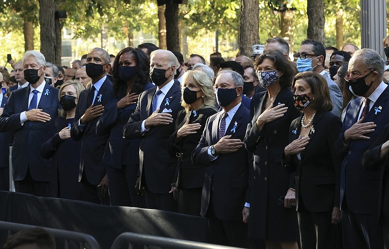 From left, former President Bill Clinton, former First Lady Hillary Clinton, former President Barack Obama, Michelle Obama, President Joe Biden, first lady Jill Biden, former New York City Mayor Michael Bloomberg, Bloomberg's partner Diana Taylor, Speaker of the House Nancy Pelosi, D-Calif., and Senate Majority Leader Charles Schumer, D-N.Y., stand for the national anthem during the annual 9/11 Commemoration Ceremony at the National 9/11 Memorial and Museum on Saturday, Sept. 11, 2021 in New York. (Chip Somodevilla/Pool Photo via AP)