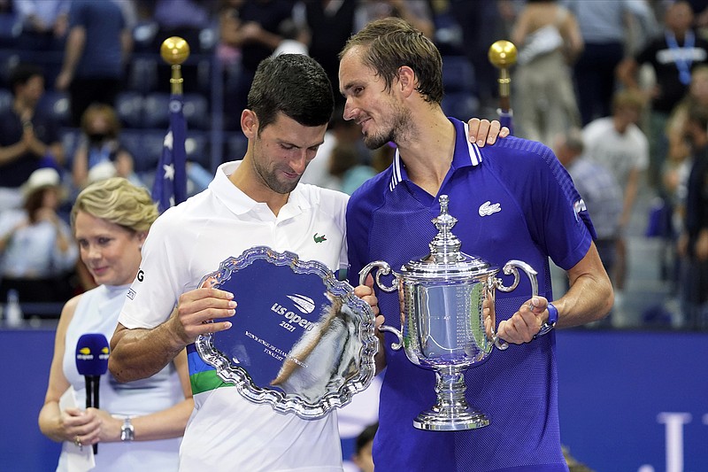 AP photo by John Minchillo / U.S. Open champion Daniil Medvedev, right, talks with Novak Djokovic after Sunday's final in New York. Medvedev won 6-4, 6-4, 6-4, ending Djokovic's bid to become the first man since 1969 to win all four major tennis tournaments in a single season and complete a true Grand Slam.