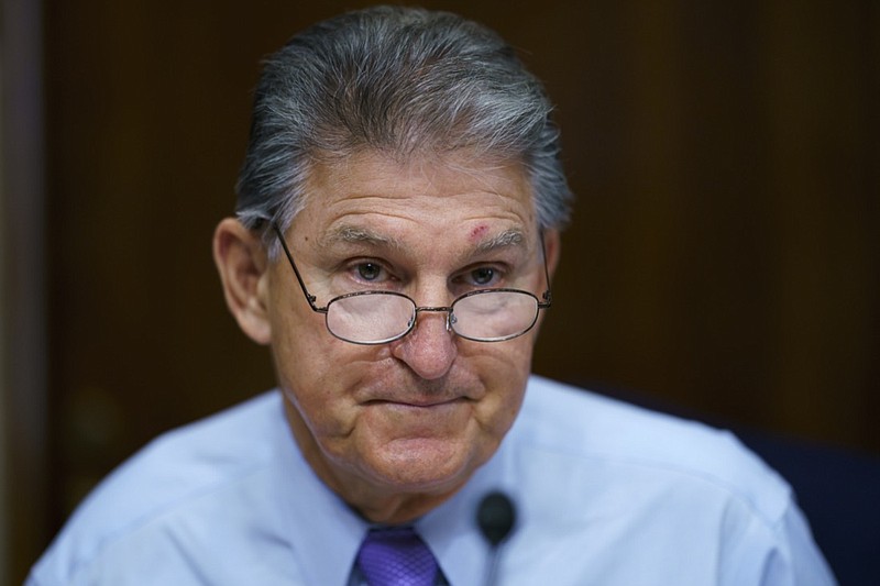 FILE - In this Aug. 5, 2021, file photo Sen. Joe Manchin, D-W.Va., prepares to chair a hearing in the Senate Energy and Natural Resources Committee, as lawmakers work to advance the $1 trillion bipartisan bill, at the Capitol in Washington. Manchin said Thursday, Sept. 2, that Congress should take a "strategic pause" on more spending, warning that he does not support President Joe Biden's plans for a sweeping $3.5 trillion effort to rebuild and reshape the economy. (AP Photo/J. Scott Applewhite, File)