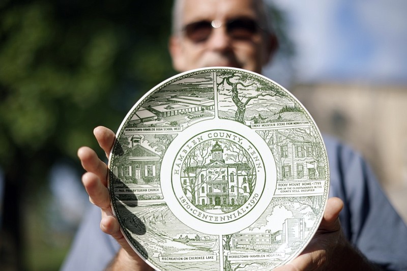 Terry Myers, maintenance supervisor at the Hamblen County Courthouse, holds a commemorative plate salvaged from a time capsule buried in 1970, Tuesday, Sept. 7, 2021 in Morristown, Tenn. (Drew C. Robinson/The Citizen Tribune via AP)