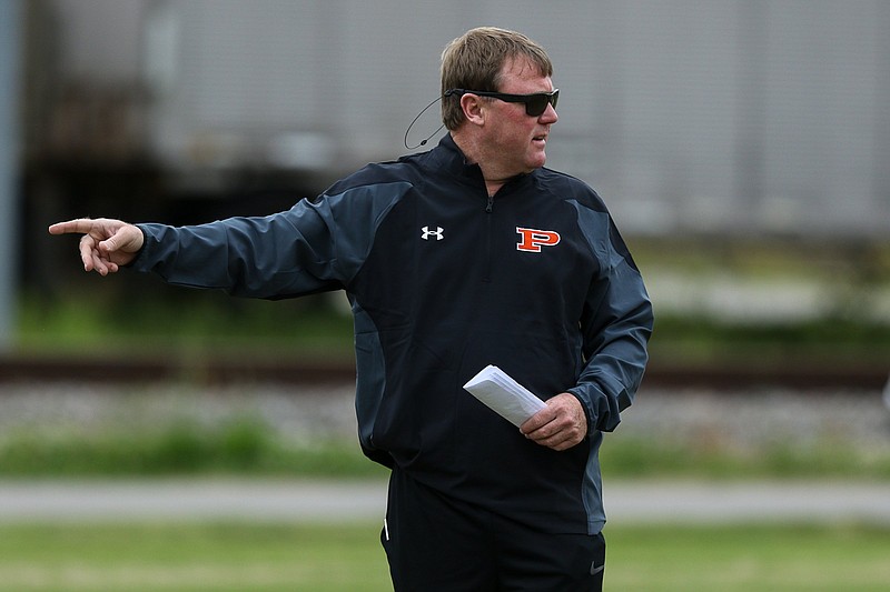 Staff photo by Troy Stolt / South Pittsburg head football coach Chris Jones instructs players during practice on Wednesday, May 12, 2021 in South Pittsburg, Tenn.