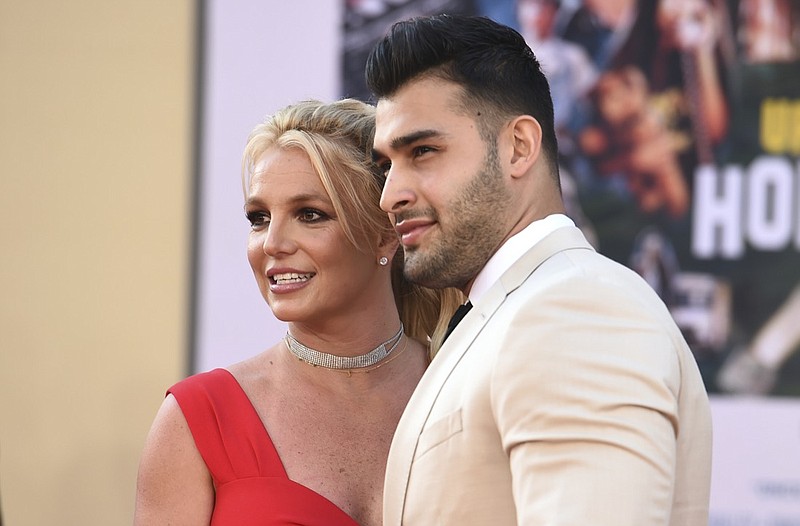 Britney Spears and Sam Asghari arrive at the Los Angeles premiere of "Once Upon a Time in Hollywood," at the TCL Chinese Theatre, Monday, July 22, 2019. Spears announced on Instagram on Sunday, Sept. 12, 2021, that she and Asghari are engaged. The couple met on the set of her "Slumber Party" music video in 2016. (Photo by Jordan Strauss/Invision/AP, File)