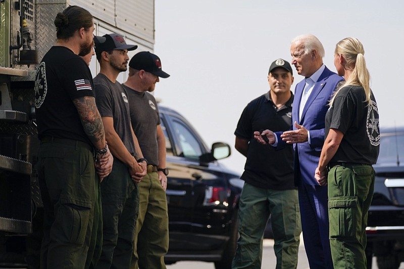 President Joe Biden greets firefighters as he tours the National Interagency Fire Center, Monday, Sept. 13, 2021, in Boise, Idaho. (AP Photo/Evan Vucci)


