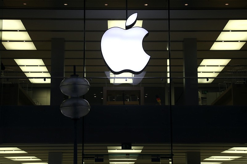 FILE - This Dec. 16, 2020 file photo shows an illuminated Apple logo at a store in Munich, Germany. (AP Photo/Matthias Schrader, File)


