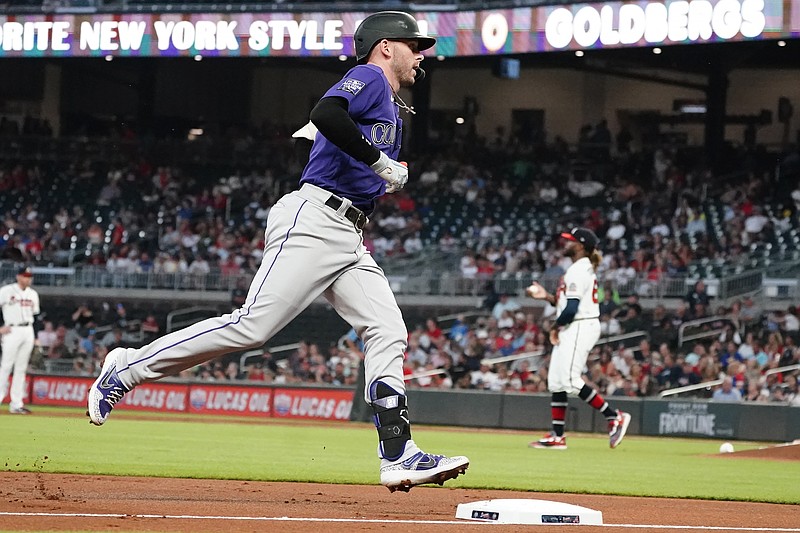 Colorado Rockies shortstop Trevor Story (27) rounds the bases after hitting a solo home run in the first inning of a baseball game against the Atlanta Braves Tuesday, Sept. 14, 2021, in Atlanta. (AP Photo/John Bazemore)