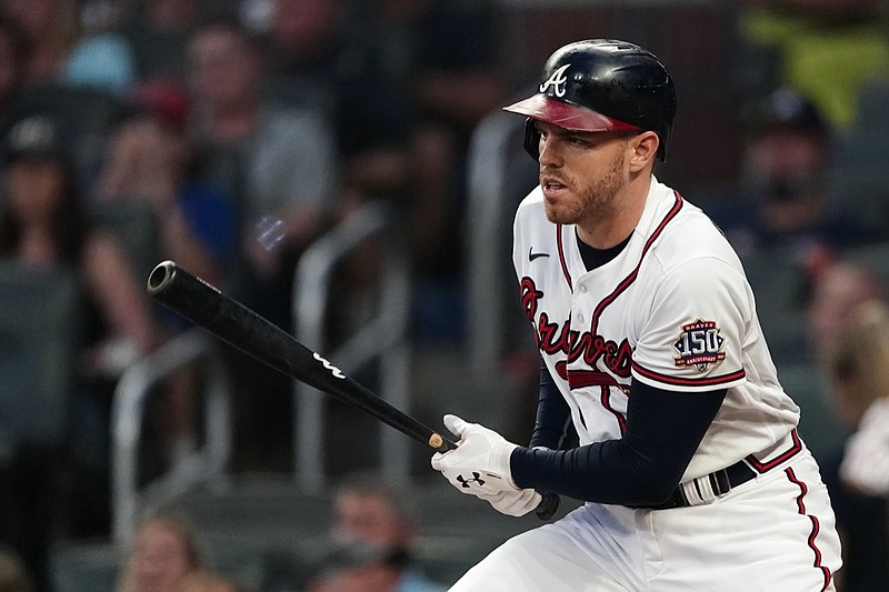 Atlanta Braves first baseman Freddie Freeman (5) drives in a run with a base hit in the first inning of a baseball game against the Colorado Rockies Tuesday, Sept. 14, 2021, in Atlanta. (AP Photo/John Bazemore)