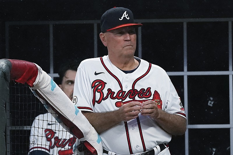 AP photo by John Bazemore / Atlanta Braves manager Brian Snitker watches Wednesday night's home game against the Colorado Rockies, who won 3-2 in 10 innings. The finale of the three-game series at Truist Park was postponed due to wet field conditions Thursday afternoon, and the Braves were set to leave town for what Snitker said will be their most difficult road trip of the season.