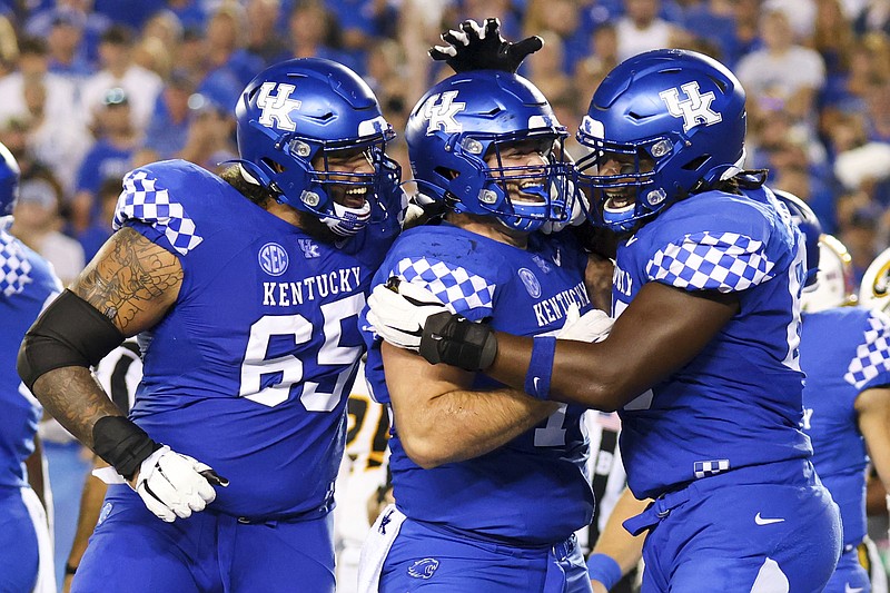 AP photo by Michael Clubb / From left, Kentucky offensive tackle Darian Kinnard and guards Eli Cox and Kenneth Horsey celebrate a touchdown during the second half of last Saturday's home win against Missouri to open SEC play. The Wildcats return to nonconference play this weekend as UTC visits Lexington.