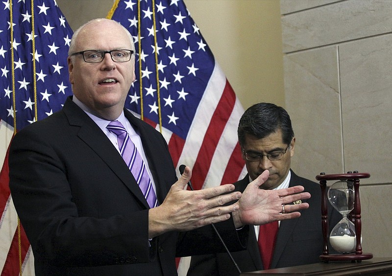 FILE - In this Feb. 25, 2015, file photo Rep. Joe Crowley, D-N.Y. left, accompanied by Rep. Xavier Becerra, D-Calif., gestures during news conference on Capitol Hill in Washington. Opposition from some leading moderate Democrats over a $3.5 trillion budget proposal championed by the party's most-liberal, progressive wing has left the party grappling with deeper ideological questions. "This is critically important for Democrats and for their message in next year's election," said former New York congressman Joe Crowley, a veteran Democrat who was upset in the 2018 primary by progressive star, Rep. Alexandria Ocasio-Cortez. "We're going to blink and we're going to be in 2022." (AP Photo/Lauren Victoria Burke, File)

