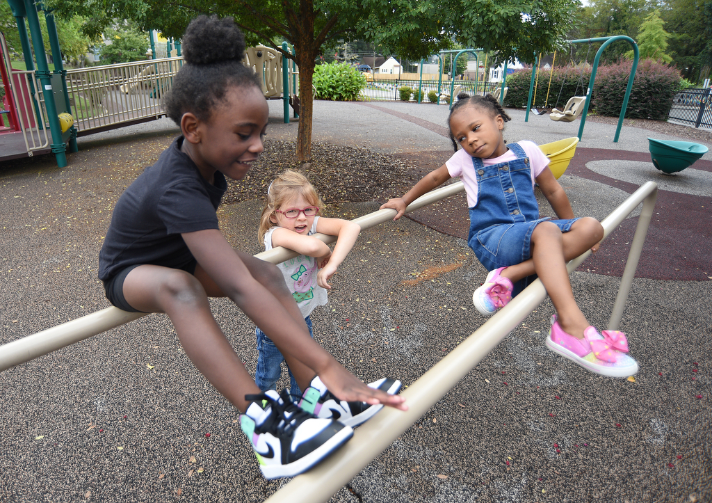 Staff Photo by Matt Hamilton / From left, Ja'zelle Jenkins, Elizabeth Hall and Ryley Boston play on the playground on Thursday, September 16, 2021 at Signal Centers. Friends of Special Children is holding a fundraiser for playground equipment for Signal Centers.
