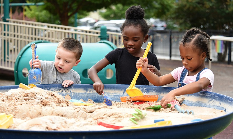 Staff Photo by Matt Hamilton / From left, Eli Glass, Ja'zelle Jenkins and Ryley Boston play with sand on Thursday, September 16, 2021 at Signal Centers. Friends of Special Children is holding a fundraiser for playground equipment for Signal Centers.