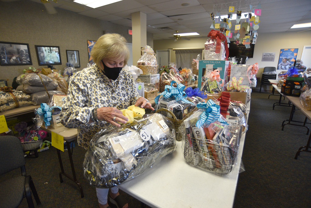 Staff Photo by Matt Hamilton / Lynn Reese, president of Friends of Special Children, prepares items for an upcoming online auction on Thursday, September 16, 2021 at Signal Centers. Friends of Special Children is holding a fundraiser for playground equipment for Signal Centers.