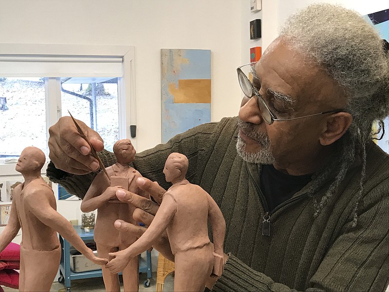 Contributed Photo / Sculptor Jerome Meadows works on a model of the Ed Johnson Memorial in his studio. The statues are being placed and dedicated at the Walnut Street Bridge this weekend.